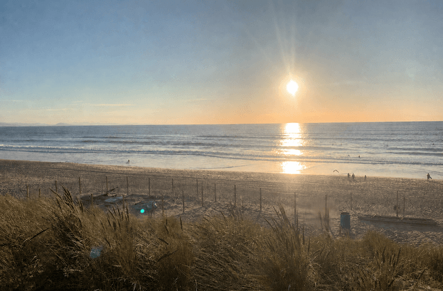 Sunset over Seignosse beach and Atlantic surf lines from the dunes.