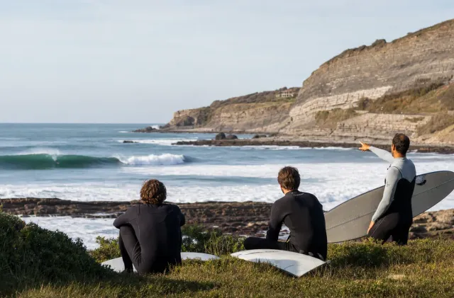 Surfers checking Parliamentia from the Bidart cliffs before entering a more advanced wave.